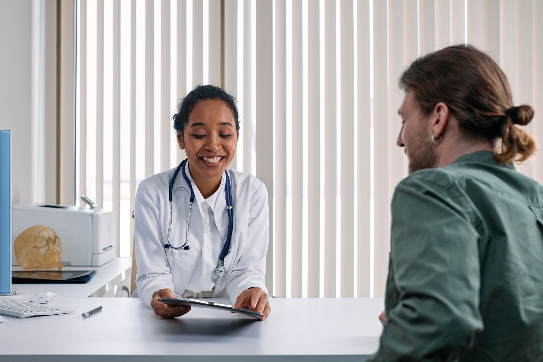 Doctor and visitor discussing a medical appointment
